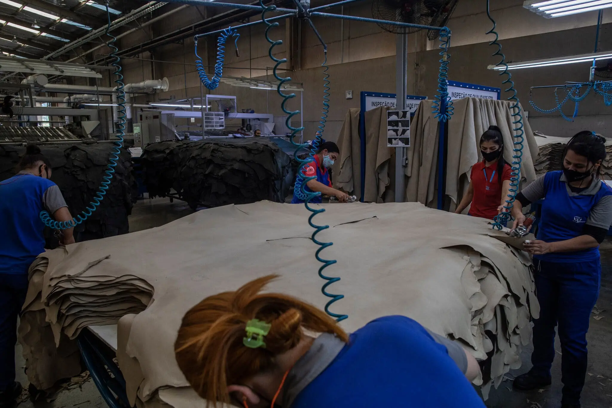 Women work on hide that will become car leather