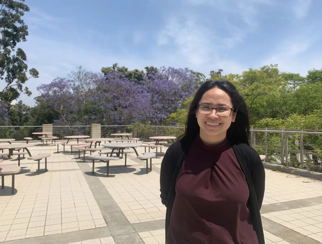 woman stands in front of picnic area