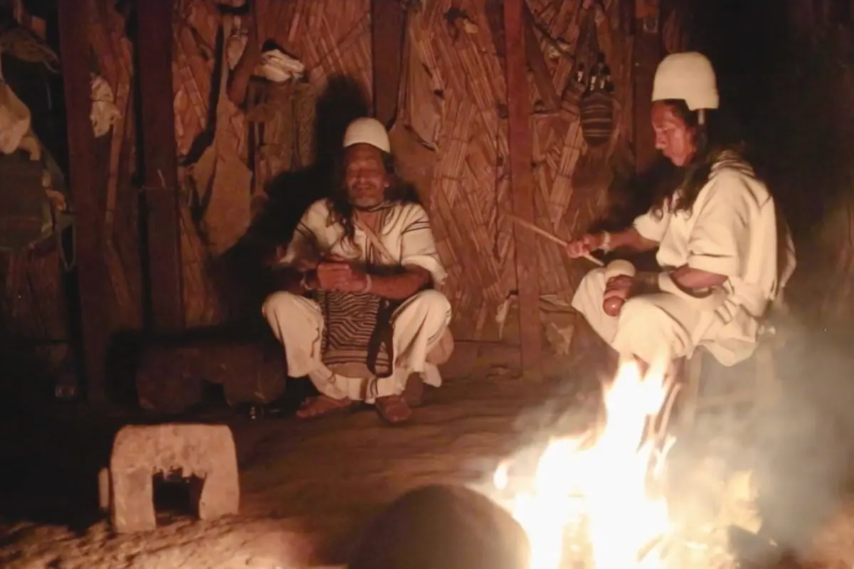 Indigenous people gather around fire
