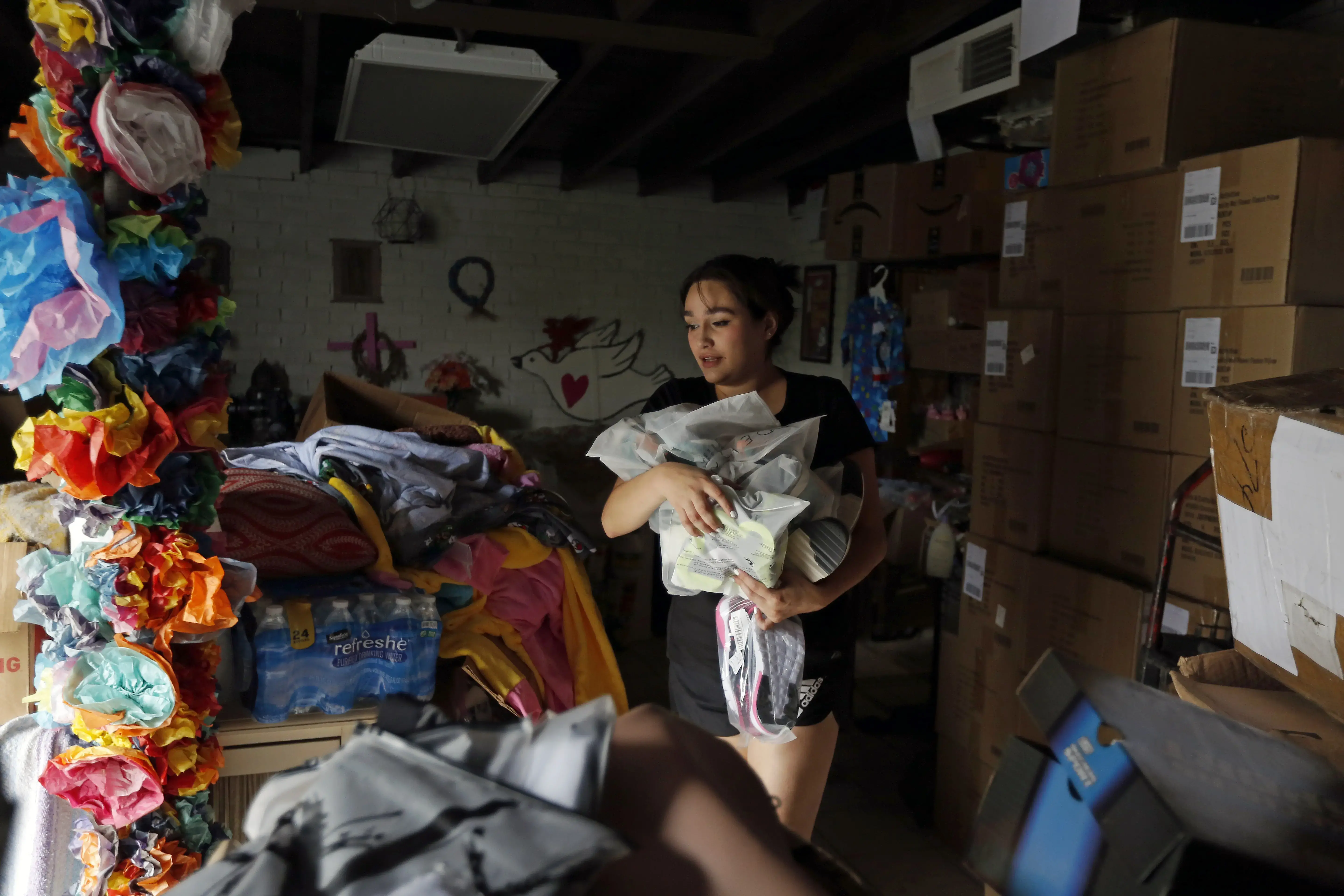 A woman holds car with supplies 