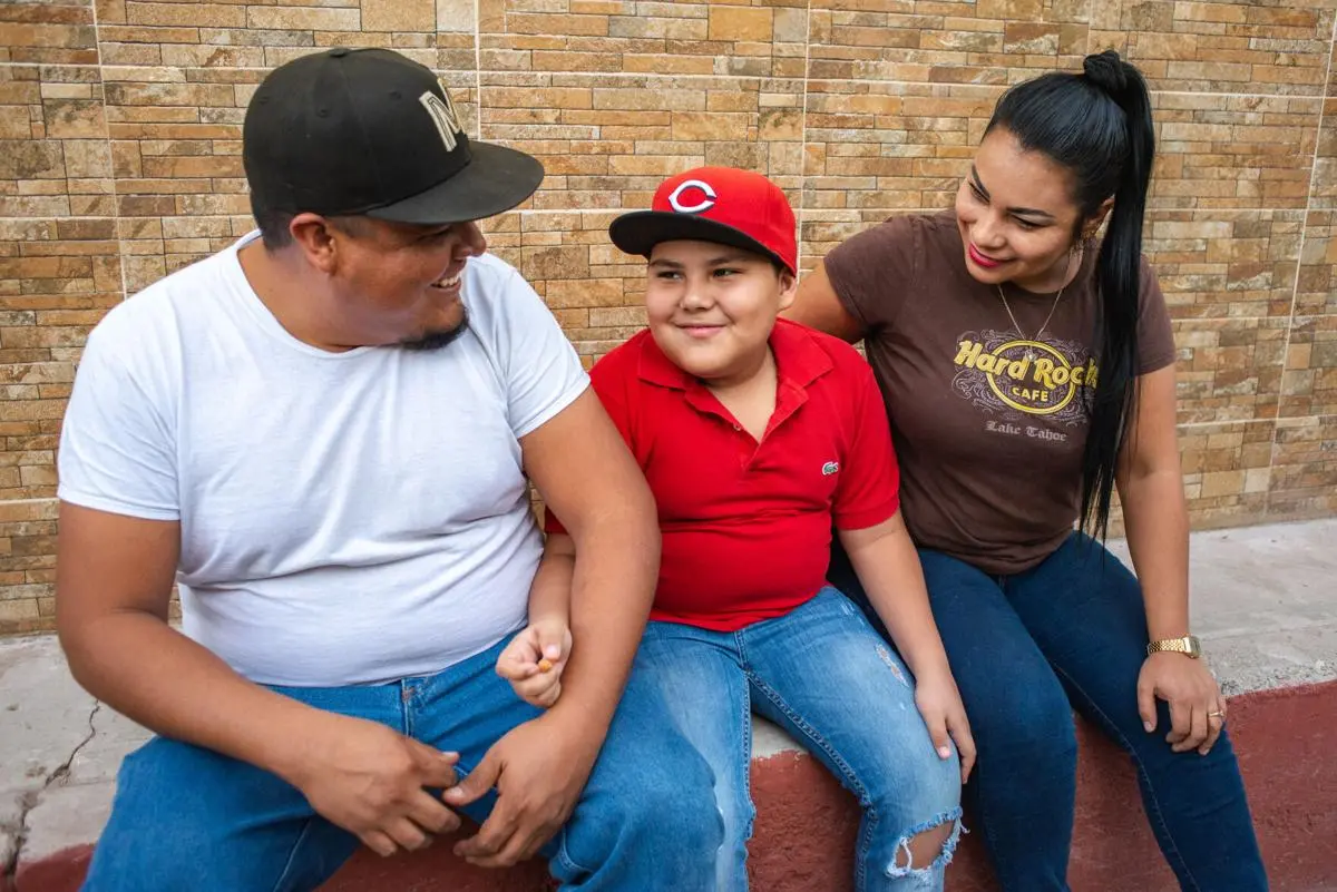 Family sits together with son