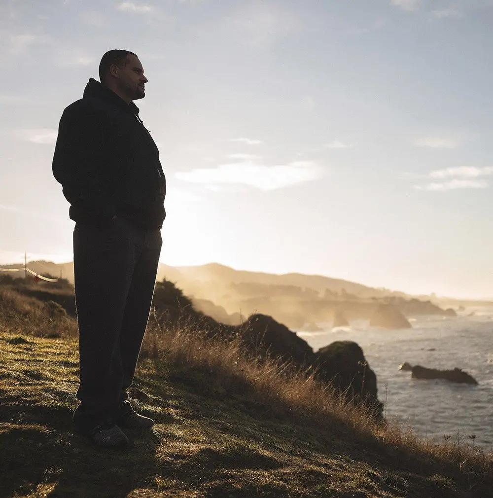 man looks out at ocean