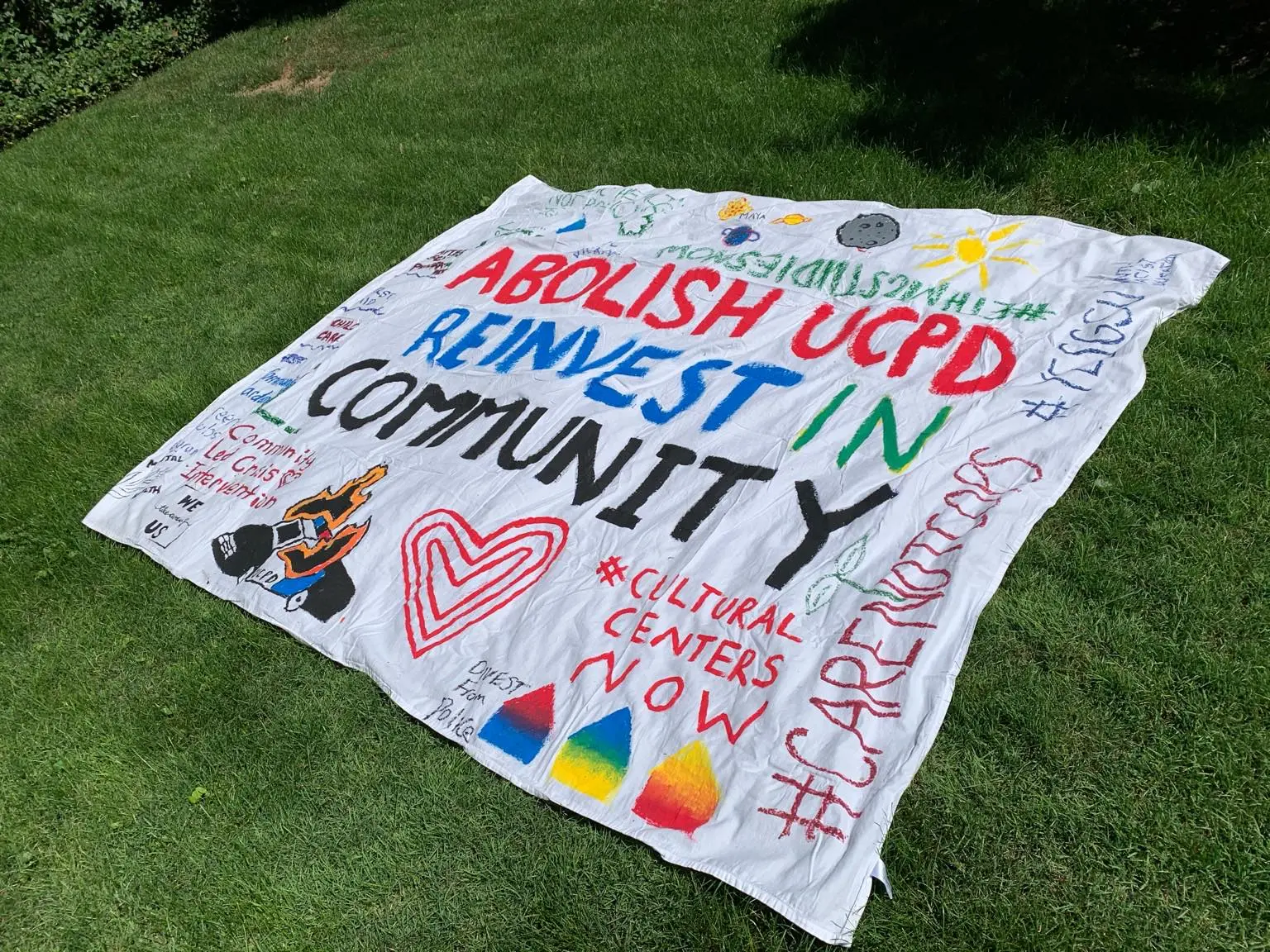 A #CareNotCops banner says "Abolish UCPD Reinvest in Community"