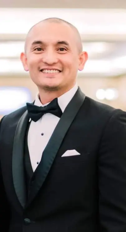 Man stands in suit.