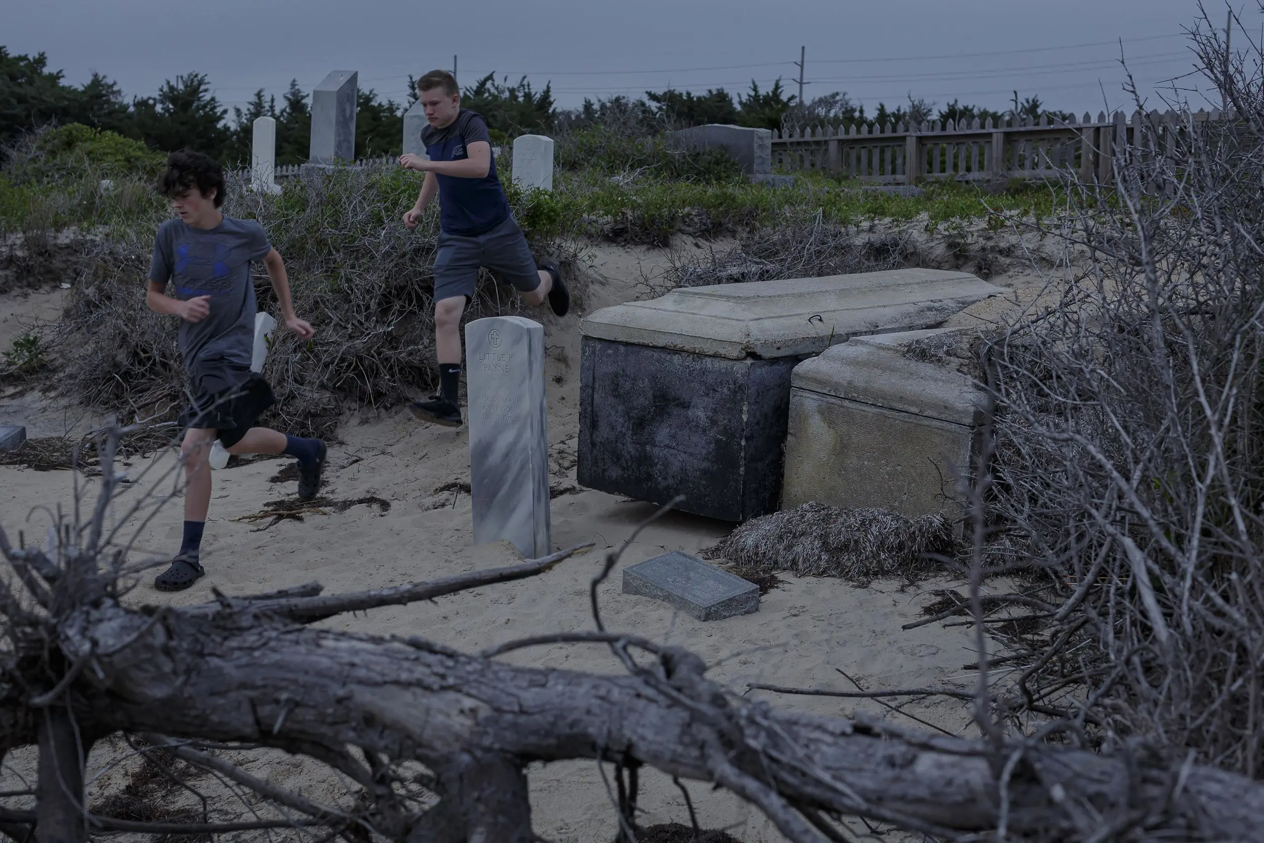 Kids run around exposed graves