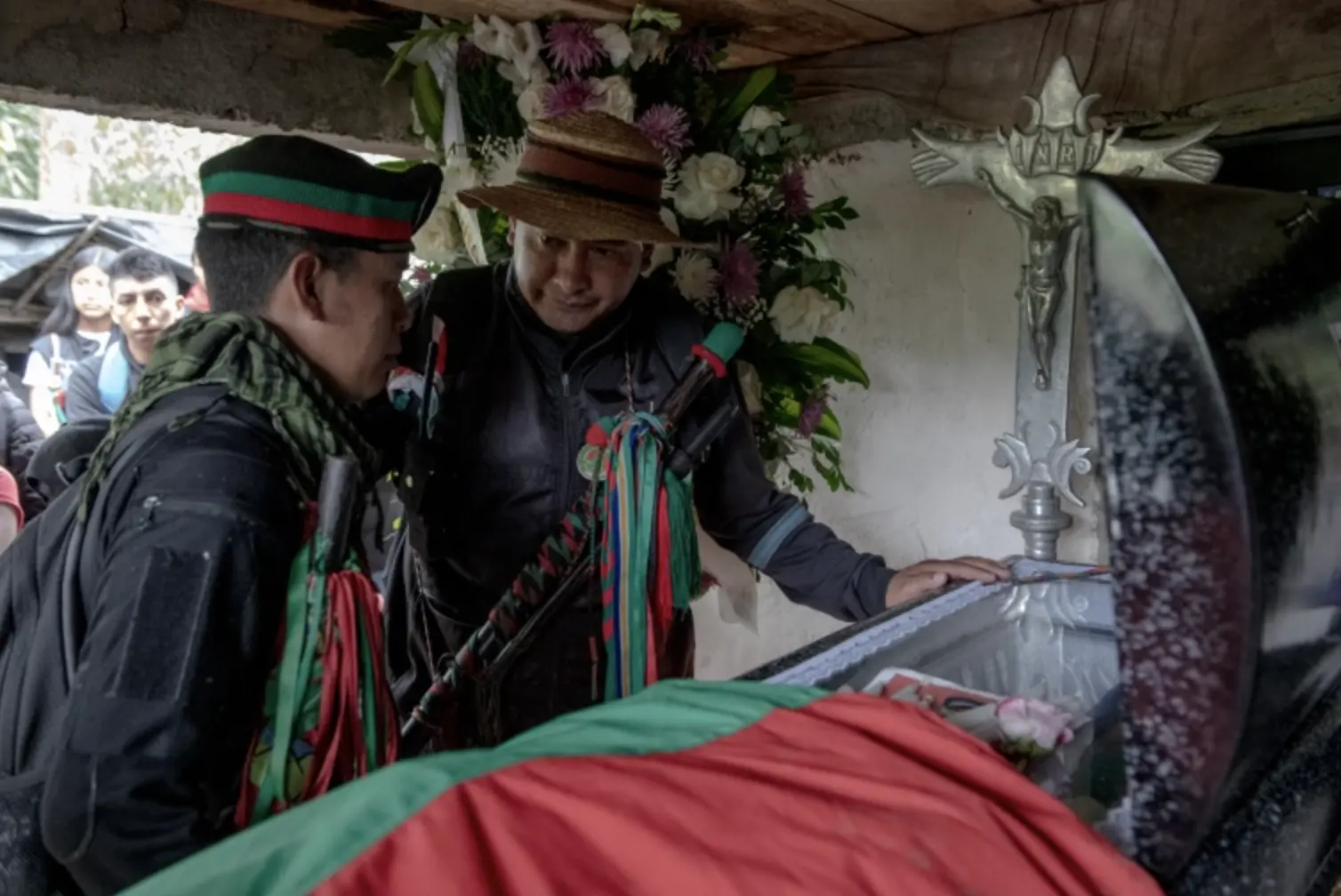 Two leaders look over coffin 
