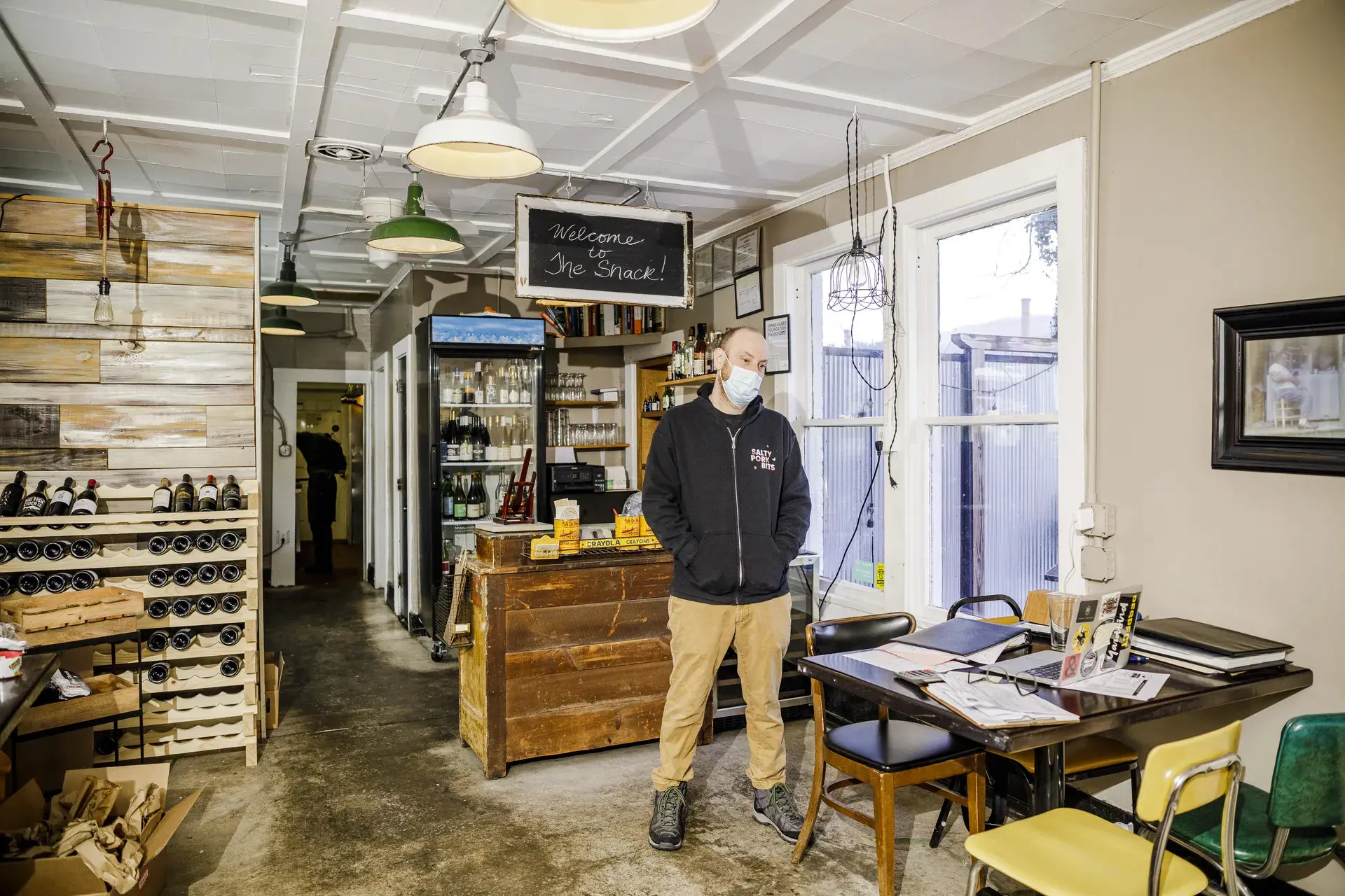 A chef stands inside his restaurant