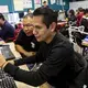 Orlando Mendoza works during classes of Hola Code, a nonprofit that offers training in software development for returnees and deportees in Mexico. Mendoza recently graduated from the program and secured a job. He grew up in Yakima and the Seattle area. Image by Erika Schultz. Mexico, 2019.