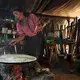 Fiorentina Hernandez, 37, has three children, two of whom have special needs—including Magda Noelia, 4 (right). Hernandez cooks breakfast over an open fire. “It’s smoky but this is how life is,” she says. She has a new cookstove but it's small and slow—and in the morning she doesn’t have the time. Image by Lynn Johnson. Guatemala, 2017.