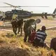 Suspected poachers caught in Chinko arrive at the park’s main base. Rangers put them in handcuffs, sit them down together, then take them to a holding cell. The moment is the culmination of a week-long operation by Chinko’s law-enforcement and aerial patrol teams. Image by Jack Losh. Central African Republic, 2018.