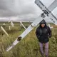 Melting permafrost is changing the landscape of northern Alaska. In the village of Teller, Carolyn Oquilluk walks through a graveyard, where the markers have tilted as the ground has shifted. Image by Steve Ringman. United States, 2019.