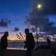 Vibrant color from the sunset provides a dramatic scene for locals and visitors at Playas de Tijuana on Nov. 29. Residents and tourists alike are drawn to the popular area for the beach, scenic views, seafood, restaurants and local bars. Image by Amanda Cowan. Mexico, 2019.