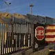 Visitors to Playas de Tijuana stop by the border wall at Friendship Park to look over artwork Dec. 1. Friendship Park is located along the United States-Mexico border in the San Diego-Tijuana region and is a half-acre in size. Image by Amanda Cowan. Mexico, 2019.