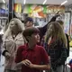 Edward Flores, 12, foreground, joins members of his family as they get directions from a shop owner on Avenida Revolucion in downtown Tijuana on Saturday, Nov. 30, 2019. With money in short supply and safety concerns for the children, the family rarely gets to make shopping trips. Image by Amanda Cowan. Mexico, 2019.