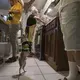 Kennedy Flores helps herself to some sparkling cider while her mother, Enedis, prepares the Thanksgiving feast and family dog, Canelo, gets food scraps from Raymond. Canelo, which means “Cinnamon” in Spanish, is one of two family dogs. Image by Amanda Cowan. Mexico, 2019.