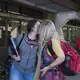 Leslie Flores, 23, shares a quick kiss with her mother, Enedis, 54, as they part ways between classes after running into each other on campus Nov. 26 at Southwestern College in Chula Vista, Calif. Image by Amanda Cowan. United States, 2019.