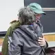 Duane Hanson embraces Roberta Benefiel-Frampton, director of the Grand River Keepers in Happy Valley-Goose Bay, Labrador, after a panel discussion at Preble Hall at the University of Maine in Farmington on Nov. 25, 2019. Image by Michael G. Seamans. United States, 2019.
