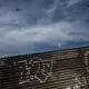 A U.S. Border Patrol helicopter watches over the border separating Tijuana, Mexico and San Diego, California. Image by James Whitlow Delano. Mexico, 2017.