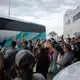 Migrants raise their hands after The Texas Tribune reporter Jay Root (back left) asked how many planned to return to Central America. Image by Miguel Gutierrez Jr. United States, 2019.