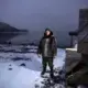 Karl Michelin poses for a portrait at the water's edge of Lake Melville in Rigolet wearing a dickie made of seal skin from a seal he hunted from the bay on Nov. 13, 2019. Image by Michael G. Seamans. Canada, 2019.<br />
