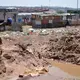 A child watches an illegal miner process gold ore by hand in a Johannesburg informal settlement. Image by Mark Olalde. South Africa, 2017.