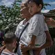 Remy Fernandez’s son, a methamphetamine user, was shot. She has been left to raise seven grandchildren. Image by James Whitlow Delano. Philippines, 2018. 