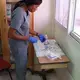 A nurse at the IHI offices prepares instuments for a breast biopsy. Image by Kate Corrigan. Haiti, 2017. 