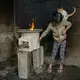 Tania López, seven, plays with her cat in a room whose walls were blackened by an old open fire; the new stove, provided by StoveTeam International, is efficient and safe to touch. Image by Lynn Johnson. Guatemala, 2017.