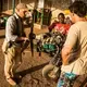 Simpson, the park manager, (left) inspects a bush plane undergoing repairs inside a hanger at Chinko. Image by Jack Losh. Central African Republic, 2018.