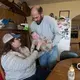 Carrie and Patrick Mess hand off their 10-month-old son, Ben, on the family's farm in Watertown. They hope to give their two sons the choice of becoming the next generation of family farmers when they become adults. Image by Mark Hoffman. United States, 2019.