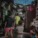 A deeply worried, Remy Fernandez (wearing a yellow T-shirt), asks if anyone has seen her daughter-in-law, Lourdes, who was missing after being released from prison on drug charges. She is looking after seven grandchildren since her son was executed. Image by James Whitlow Delano. Philippines, 2018. 