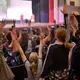 Eager students volunteer to participate in acrobatics onstage. Image by Dermot Tatlow. United States, 2018. 