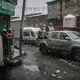 Miners brave snow in the back of a truck on the streets of La Rinconada, a gold-mining town in the Peruvian Andes. Peru, 2019. Image by James Whitlow Delano.