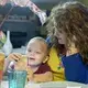 Crystal Camacho plays a game on her phone with her son, Elias, 4, at the kitchen table of their home in Swannanoa on June 30. Image by Angeli Wright/Asheville Citizen Times/North Carolina News Collaborative. United States, 2020.</p>
<p>