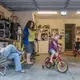 Elias and Crystal Camacho watch sons Elias, 4 (left), and Asher, 7, play in the garage of their Swannanoa home on June 30. Before finding a new day-care center for Elias after the one he was attending closed because of the COVID-19 pandemic, Camacho and her husband either took turns staying home half-days or taking the boys with them to work. Image by Angeli Wright/Asheville Citizen Times/North Carolina News Collaborative. United States, 2020.</p>
<p>