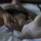 Jim Detweiler, of Williamsburg, Iowa, receives an acupuncture treatment from Dr. Zhang Shulin on Wednesday, Sept. 20, 2017, at the St. Regis hotel in Tianjin, China. Detweiler came to China to use traditional medicine as a treatment for his chronic inflammatory demyelinating polyneuropathy. Image by Kelsey Kremer. China, 2017.