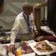Rob Shuey, Vice President of international sales for Tyson Fresh Meats makes room at the Tyson booth for samples of U.S. Beef to be served at the China, U.S. Beef road show on Monday, Sept. 25, 2017, at the Intercontinental Hotel in Beijing. The road show was meant to introduce Chinese buyers to U.S. Beef after the recent opening of that market. Image by Kelsey Kremer.
