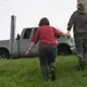 Brandi and Emily Harris walk to their truck to check on two cows that got loose while being loaded onto a truck. Image by Mark Hoffman. United States, 2019.