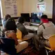 Students work with photojournalist Meghan Dhaliwal to edit Stuck in the System. Image by Claire Seaton. United States, 2019.
