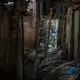 The alleyway, guarded by a neighbour’s dog, in front of Rhoda’s house floods so badly and so often that a makeshift plank boardwalk has been laid down. Image by James Whitlow Delano. Philippines, 2018. 