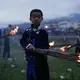An Yi boy holds a flaming torch during Torch Festival celebrations in Liangshan Prefecture, Sichuan province. Image by Max Duncan. China, 2016.