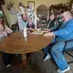 The Mess family, Carrie Mess, from left, with her 10-month-old son, Ben; husband, Patrick, with 3-year-old son Silas; and Cathy and Clem Mess, gather around their kitchen table on their farm in Watertown. Image by Mark Hoffman. United States, 2019.