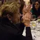 Pulitzer Center board member Linda Winslow applauds the special performance by Indigo Passariello. Image by Lorraine Ustaris. Washington, D.C., 2018.