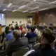 Reporting fellows and other audience members listen to M. Saad Ejaz and Juyoung Choi (Northwestern University in Qatar) present on Yemeni refugees who relocated to South Korea on Day One of Washington Weekend. Image by Meerabelle Jesuthasan. United States, 2019.