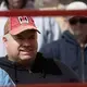 Dale Ryan watches people bid on livestock. Image by Mark Hoffman. United States, 2019.