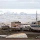 Boats and icebergs lie in Qaanaaq harbor. Vessels can only enter the harbor from late June or July until September; the sea is frozen for the rest of the year. Greenland, 2019. Image by Anna Filipova.