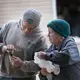 Hans Breitenmoser Jr. shows his mother, Margaret, something on his phone. Breitenmoser, the son of Swiss immigrants, milks about 350 cows on his dairy farm in Merrill in Lincoln County. Image by Mark Hoffman. United States, 2019.