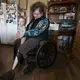 Cathy Mess holds her 10-month-old grandson, Ben. Mess used to help with many of the chores on the farm before she lost her left leg in a farm accident. Image by Mark Hoffman. United States, 2019.