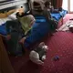 27-year-old Illham Saleh watches her six-month-old baby, Faraj, try to roll over while at a hotel in Kastoria, Greece, near the Albanian border. Image by Lynsey Addario. Greece, 2017.