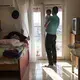 Yousuf Arsan, 27, sings to baby Rahaf, almost 6 months, while his wife (not shown) Noor Al Talaa, 22, cooks lunch at an apartment in Sidros. Image by Lynsey Addario. Greece, 2017.